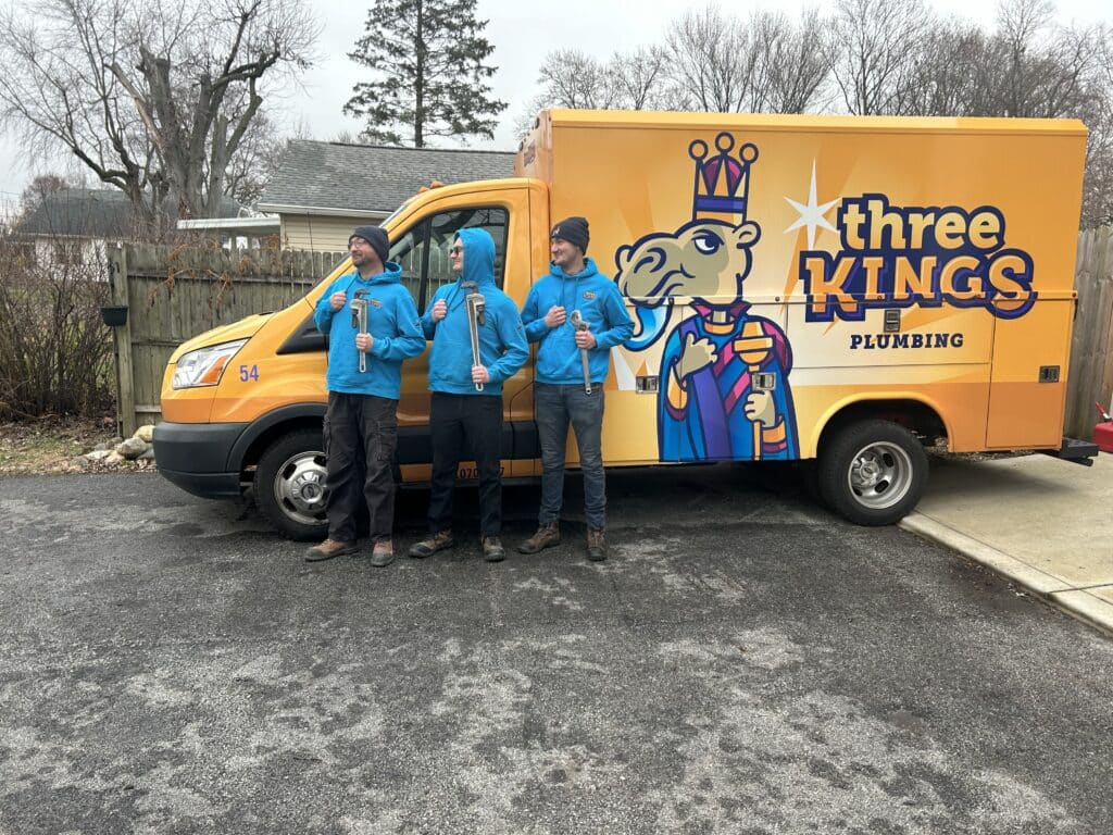 Three Kings employees posing in front of work truck