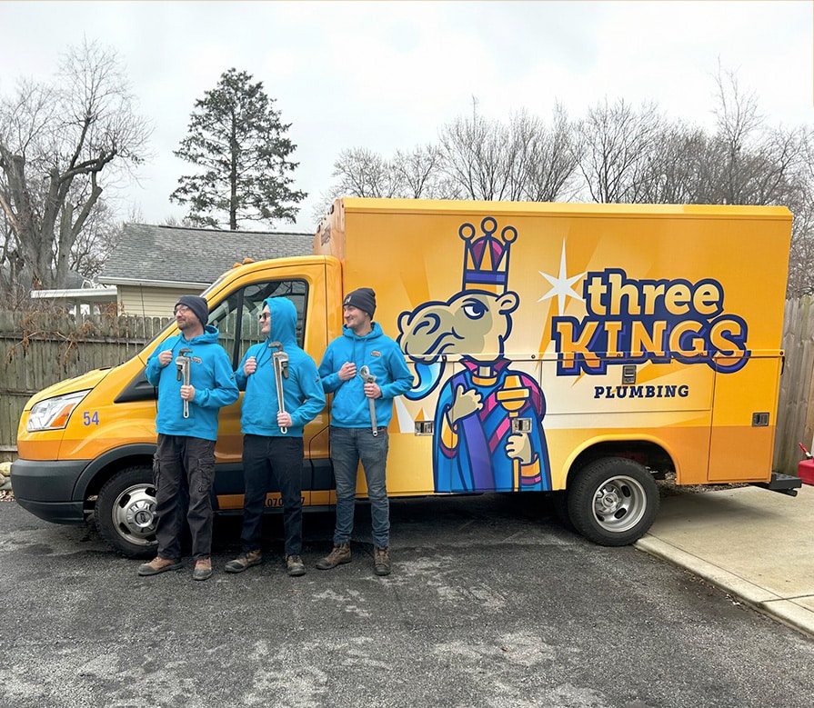 Three Kings employees posing in front of work truck