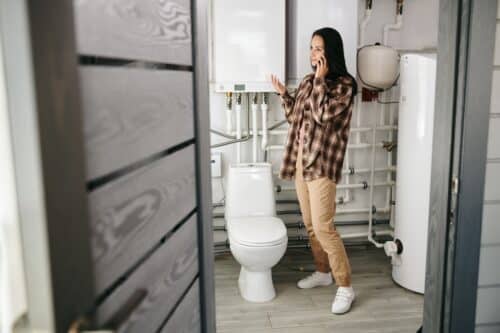 woman in basement bathroom to see if sewage ejector pump is needed